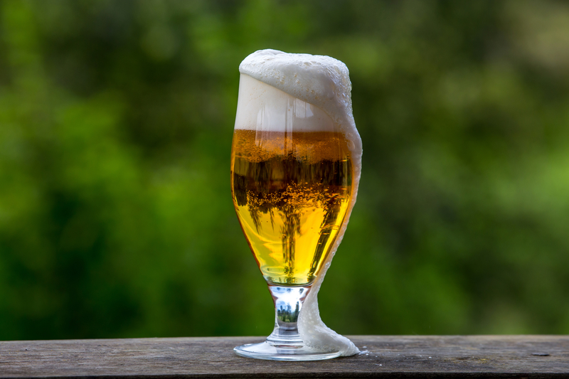 Tall sniffer glass of light lager