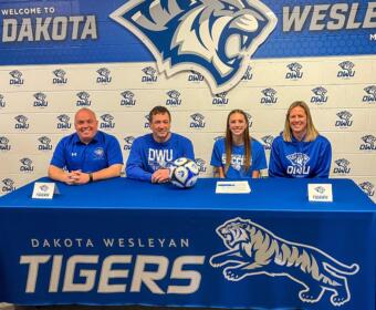 soccer players commits to DWU with parents and future coach