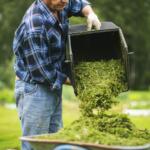 Man putting grass clippings in recycling container