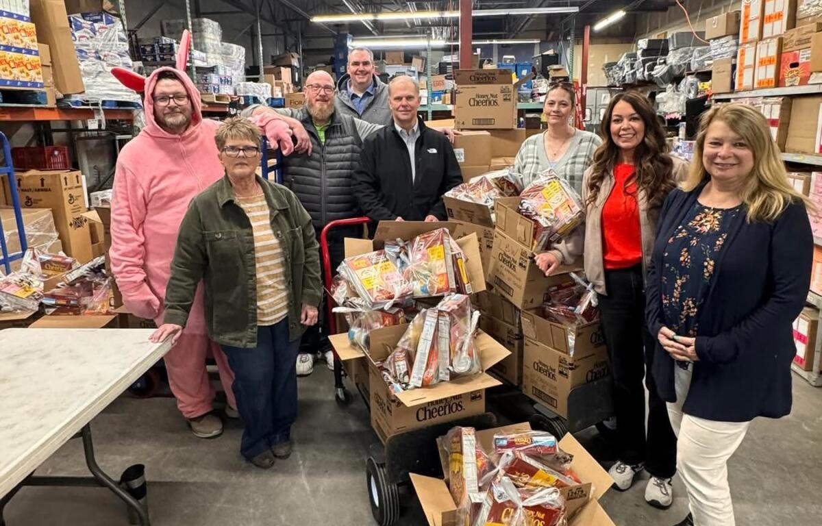 Volunteers prepare weekend snack packs for Mitchell students, part of a program distributing more than 90,000 food items annually.