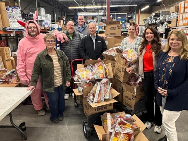 Volunteers prepare weekend snack packs for Mitchell students, part of a program distributing more than 90,000 food items annually.