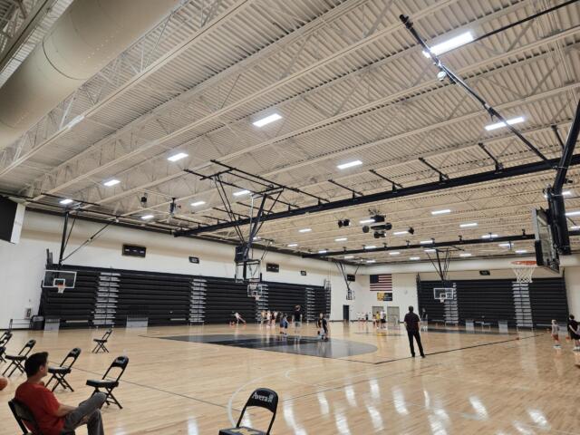 Kids and coaches in a gym for a basketball camp