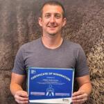 Tokata Youth Center's Aaron Vaughn with an award from the "Who Powers You" contest.