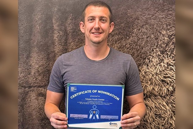 Tokata Youth Center's Aaron Vaughn with an award from the "Who Powers You" contest.