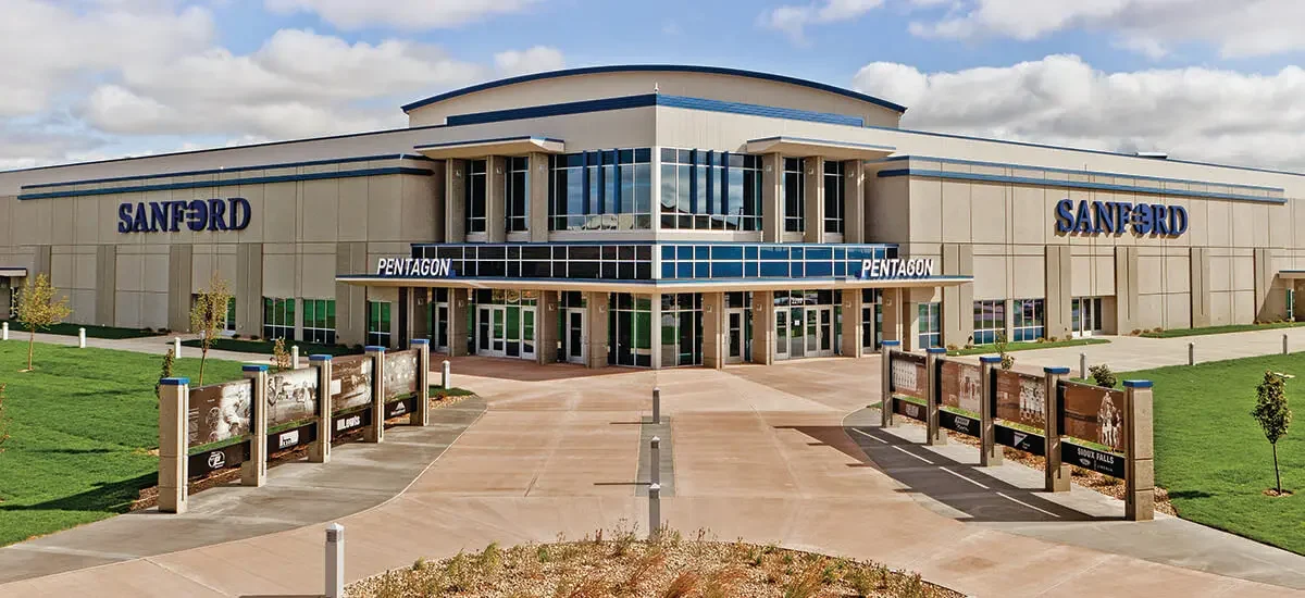 Front of Sanford medical center with 'PENTAGON' entrance and blue-accented glass atrium in the center.