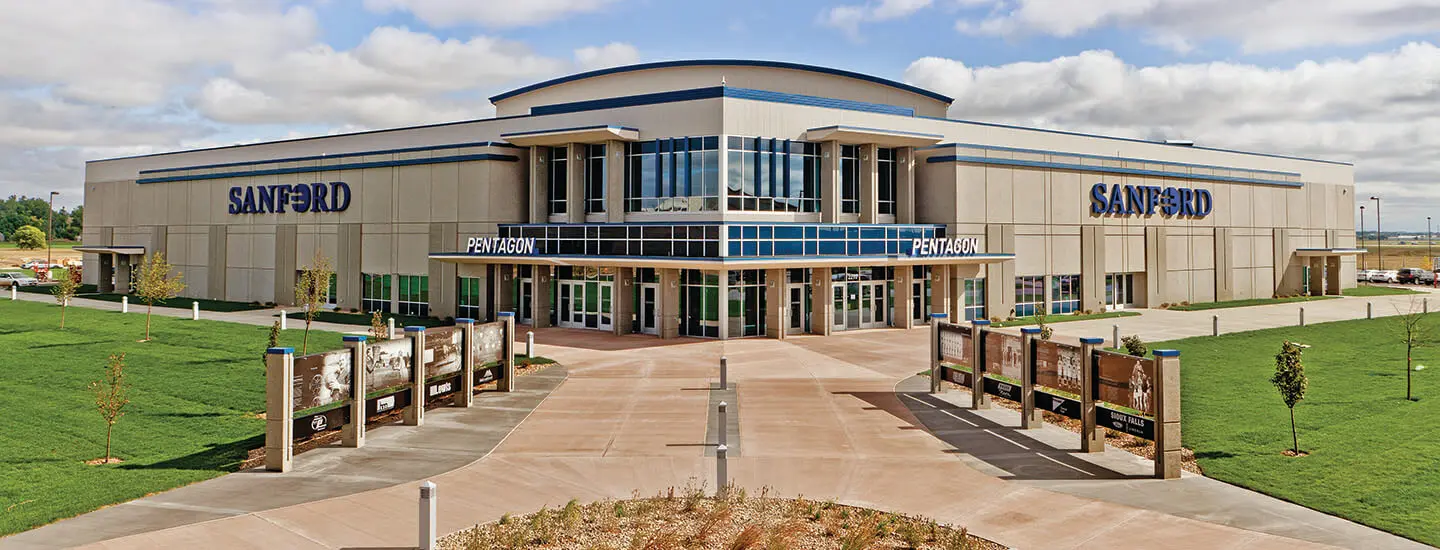 Front of Sanford medical center with 'PENTAGON' entrance and blue-accented glass atrium in the center.