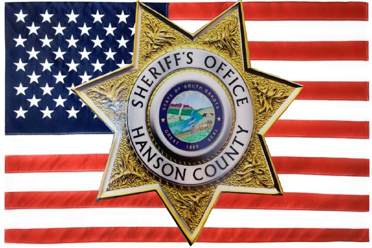Hanson County Sheriff badge with American flag background.