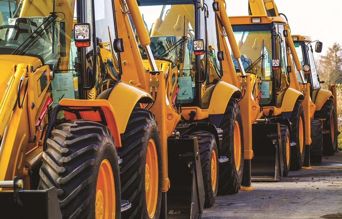 Rows of heavy equipment in a parking lot