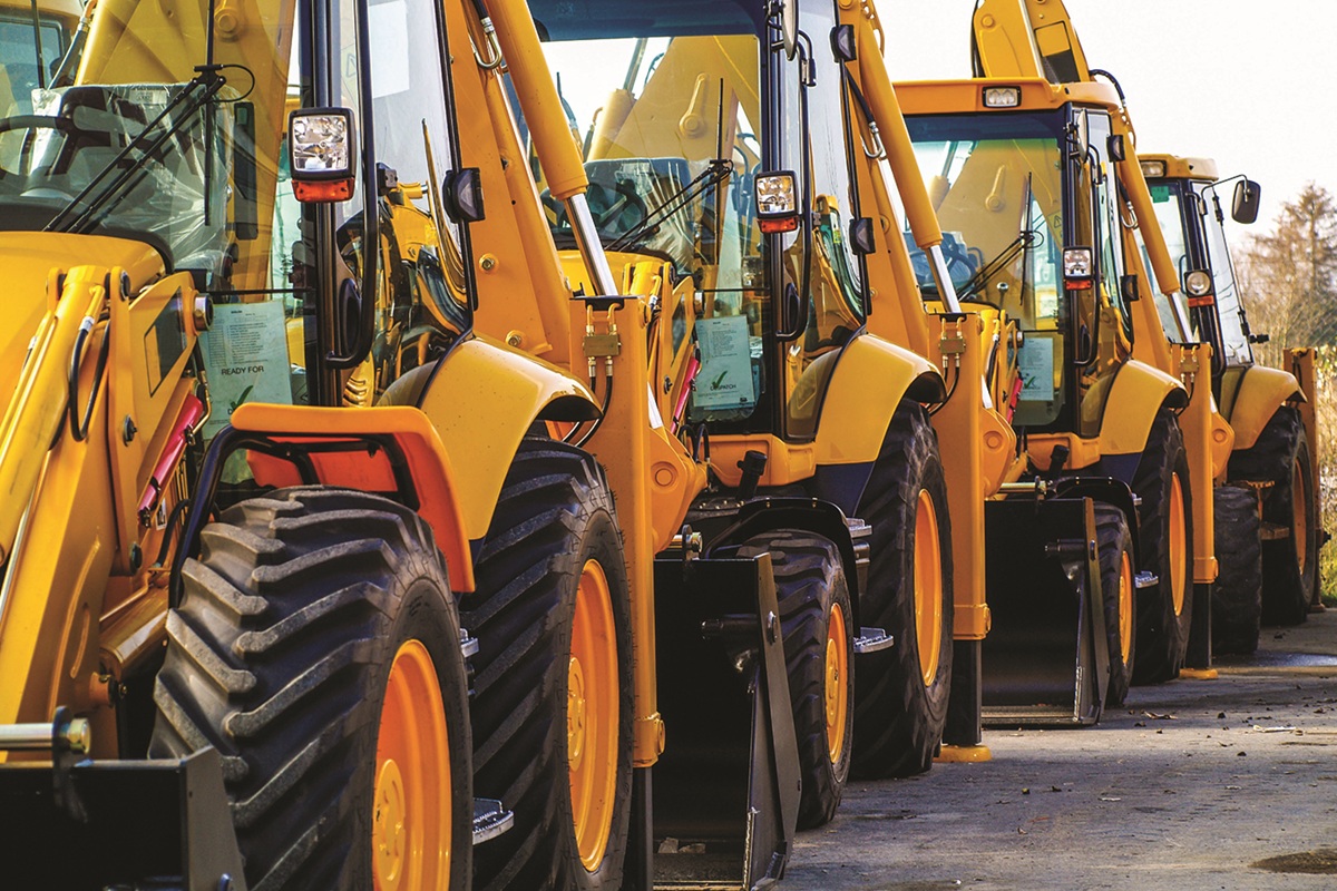 Rows of heavy equipment in a parking lot
