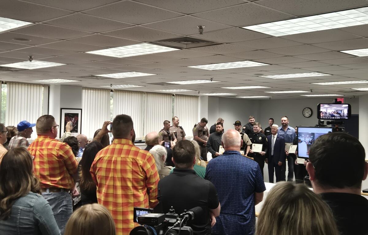 Crowd applauds after six awards were handed out for courage in saving two young children from a burning car in April
