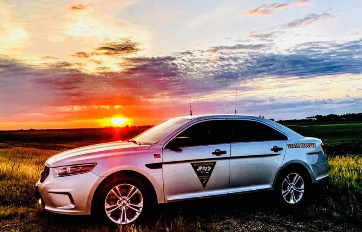 South Dakota Highway Patrol vehicle in front of a sunset