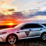 South Dakota Highway Patrol vehicle in front of a sunset