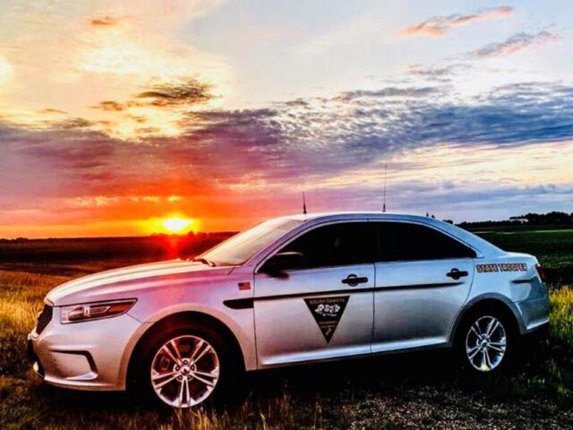South Dakota Highway Patrol vehicle in front of a sunset