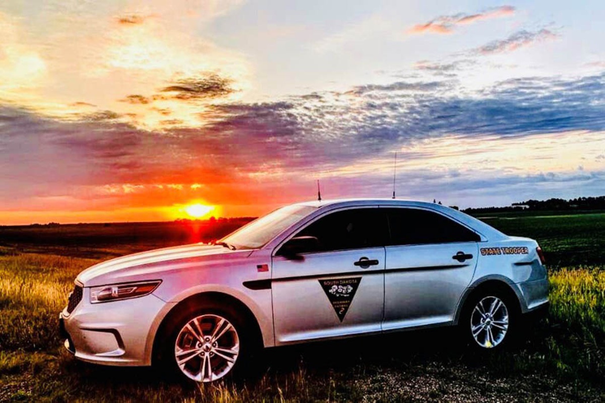 South Dakota Highway Patrol vehicle in front of a sunset