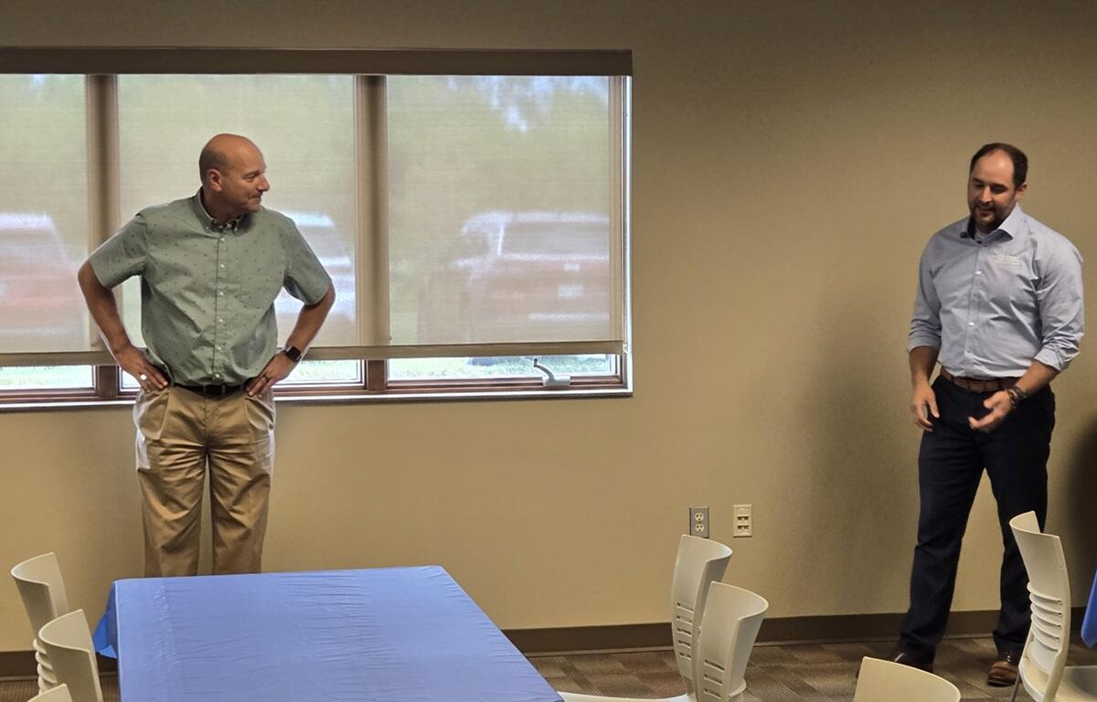 Ken Schlimgen, left, is presented with retirement gifts.