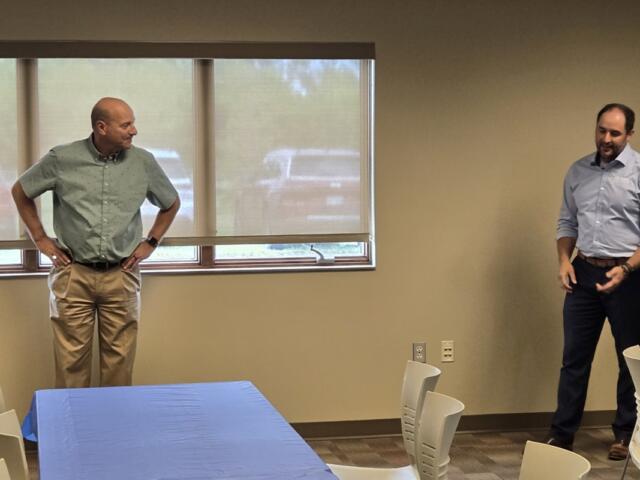 Ken Schlimgen, left, is presented with retirement gifts.