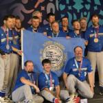 The South Dakota Special Olympics softball team poses with the state flag and their silver medals at the 2026 USA Games