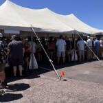 Throngs of people beat the heat under the tent at Saturday's Palace City Brewing Switchyard Social.