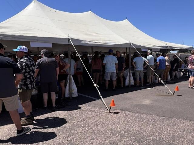 Throngs of people beat the heat under the tent at Saturday's Palace City Brewing Switchyard Social.