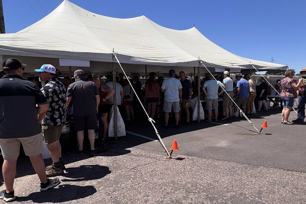 Throngs of people beat the heat under the tent at Saturday's Palace City Brewing Switchyard Social.