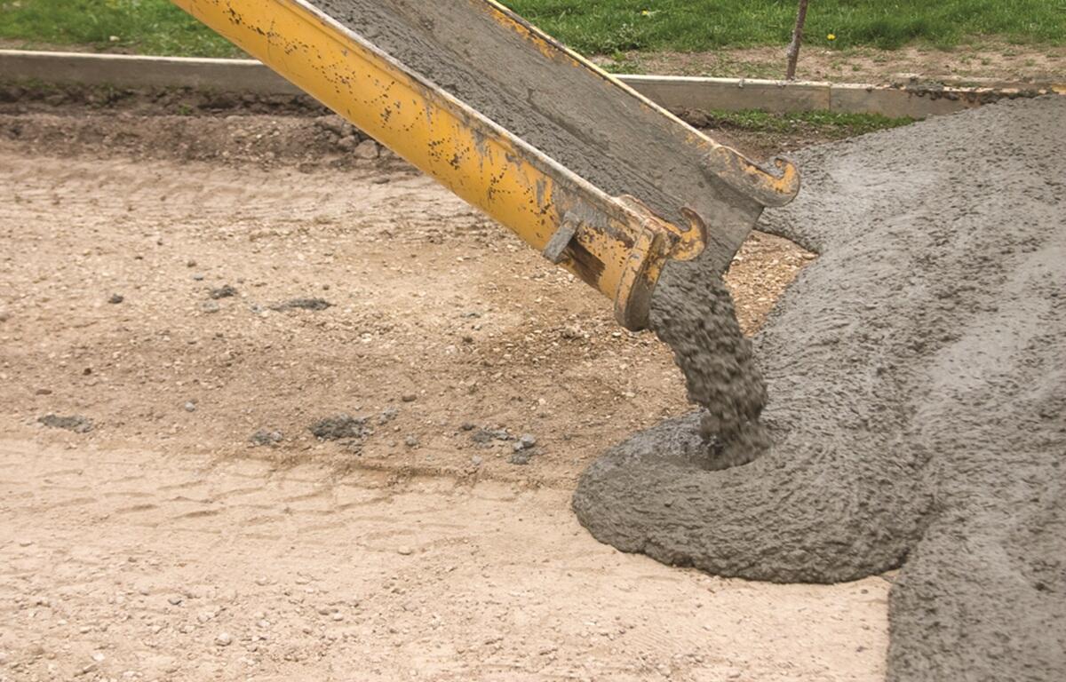 Cement being poured onto road foundation.