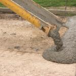 Cement being poured onto road foundation.