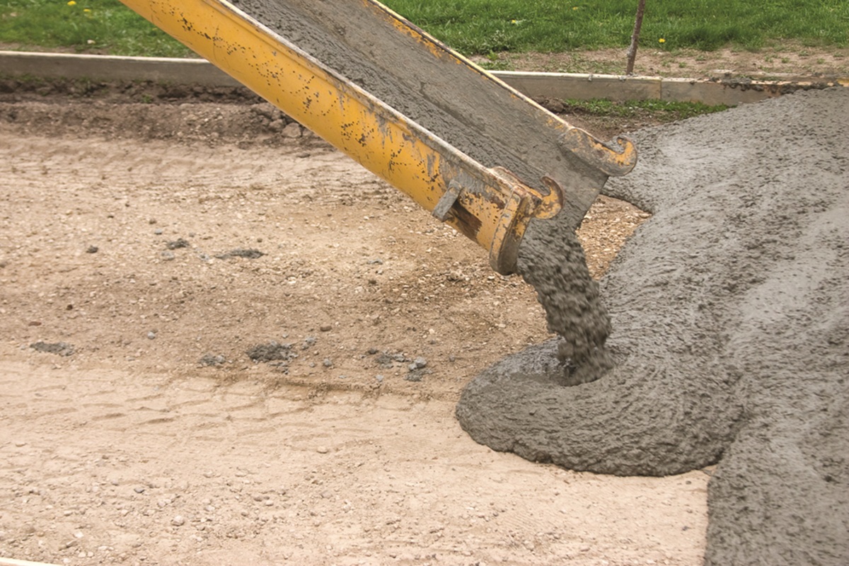 Cement being poured onto road foundation.