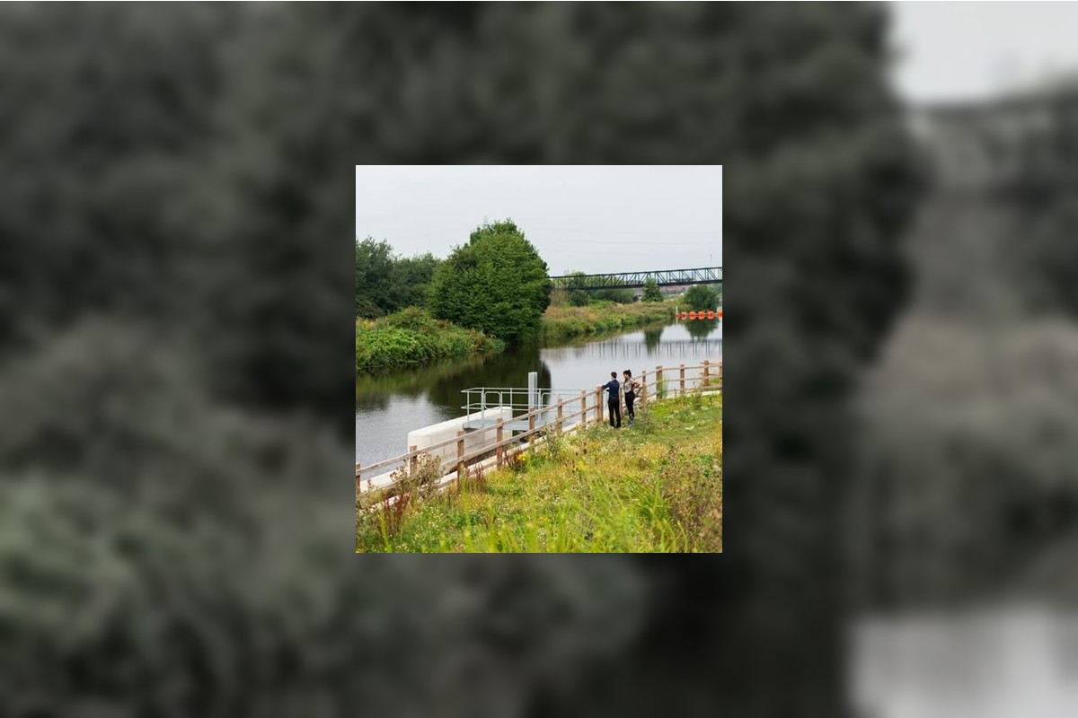 Two employees taking detailed notes about a lake shoreline