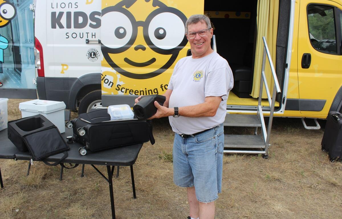 Lions member Paul Miskimins holds the vision screening equipment he uses to help check kids' eyesight.
