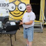 Lions member Paul Miskimins holds the vision screening equipment he uses to help check kids' eyesight.