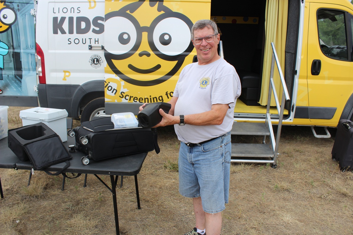 Lions member Paul Miskimins holds the vision screening equipment he uses to help check kids' eyesight.