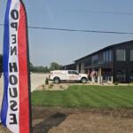 Open house roadside banners welcomes people to the new Mitchell Business Center on Monday, July 27