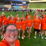 Mitchell Area Children's Choir and directors on the field ready to sing the anthem before a Twins game 7-10-26.