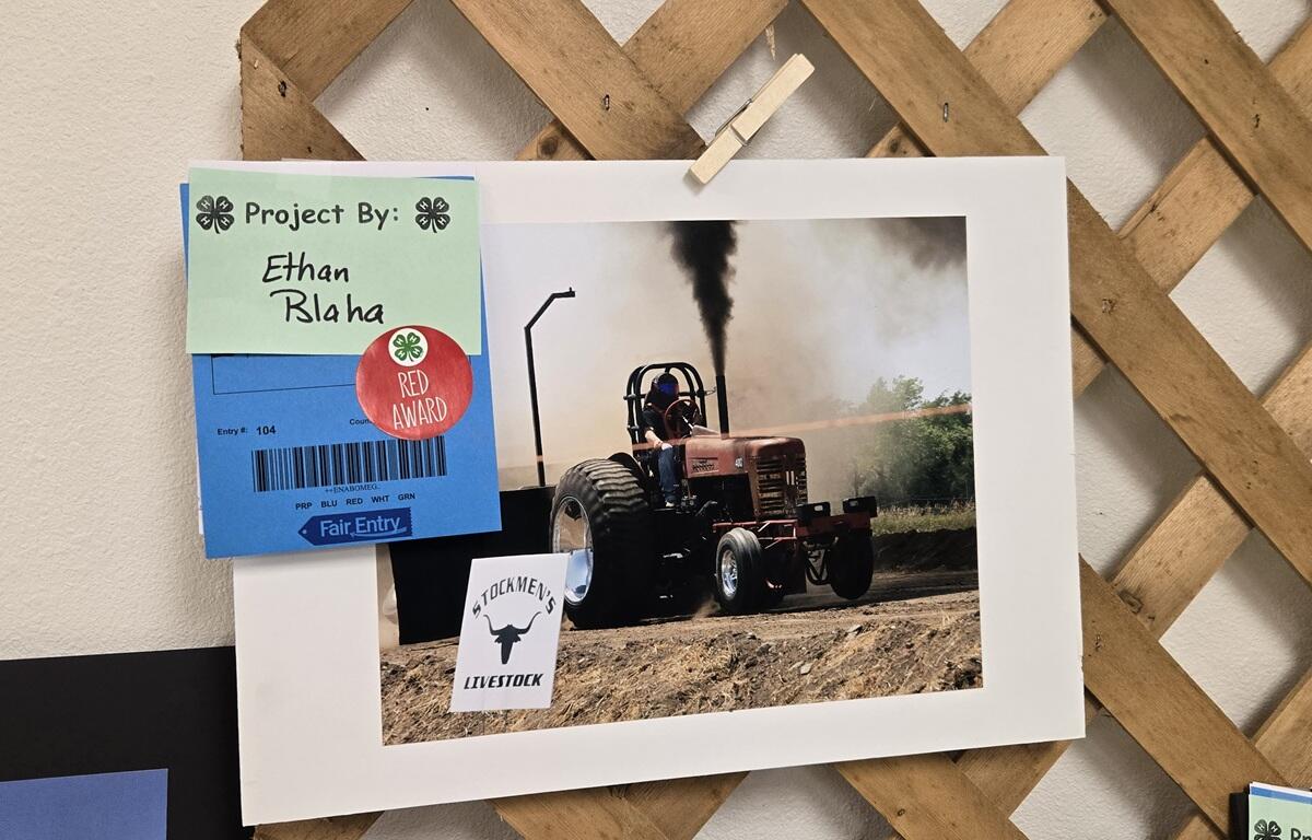 Award winning photo of tractor throwing off smoke while working the fields