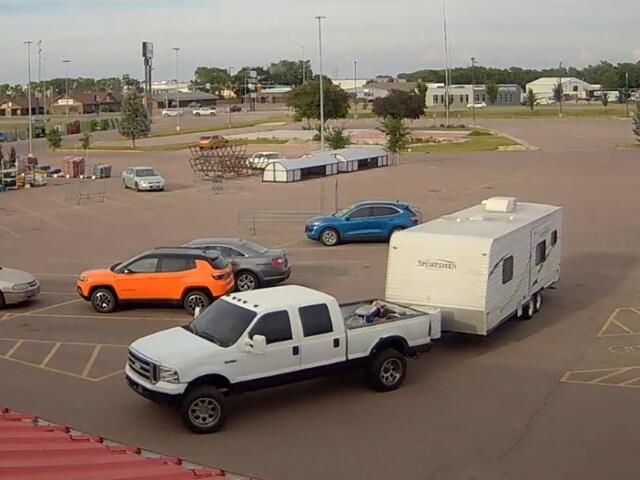1999-2001 white Ford F-250 pulling camper, suspect's vehicle in shoplifting case