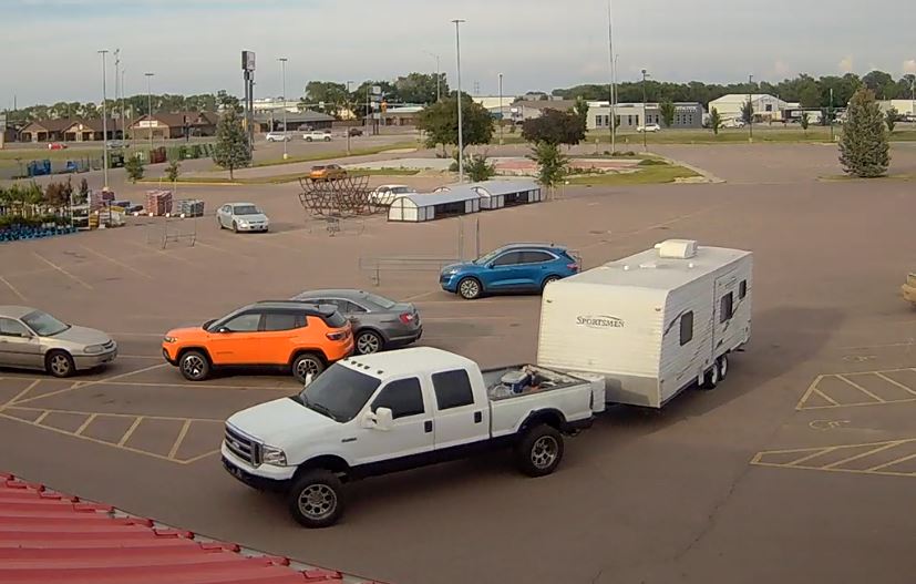 1999-2001 white Ford F-250 pulling camper, suspect's vehicle in shoplifting case