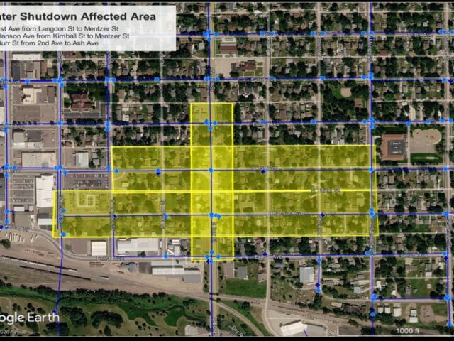 Aerial map with blue street grid and a yellow highlighted block area labeled 'Water Shutdown Affected Area,' showing the water shutoff zone over streets and avenues.