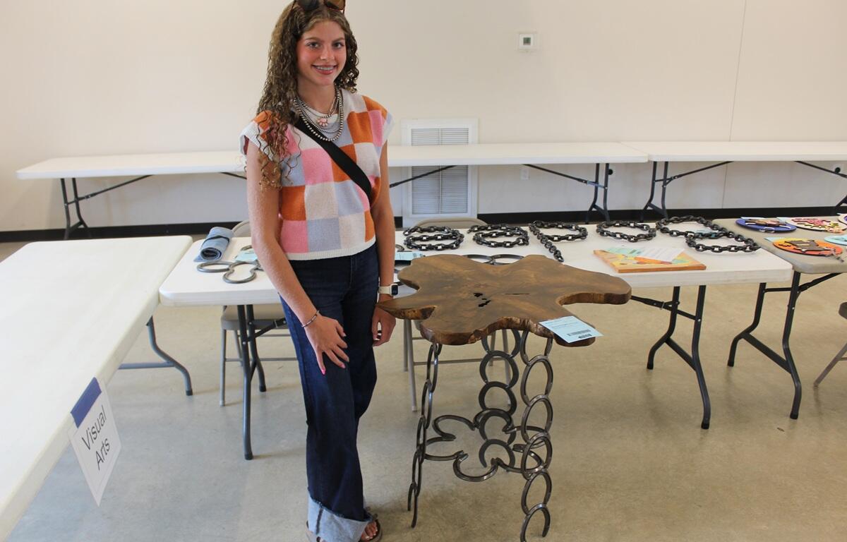 Bristol Nydam with a wooden table she entered in this year's 4-H Achievement Days